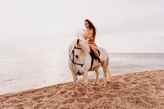 Happy woman and a white horse against the background of the sky and the sea