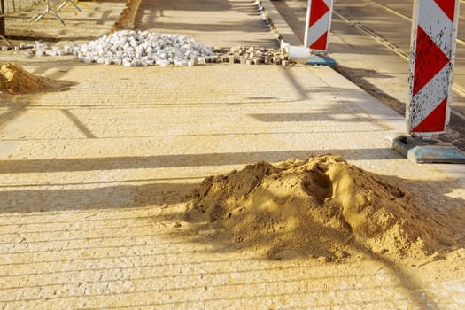 A pile of European square white paving stones at a construction site in Prague, Czech Republic. Construction of sidewalks.