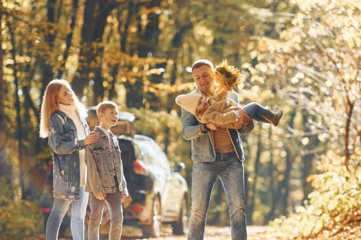 Beautiful leaves. Happy family is in the park at autumn time together.