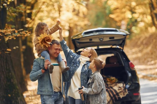 Weekend activities. Happy family is in the park at autumn time together.