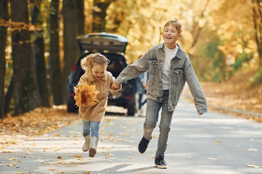 Weekend activities. Happy family is in the park at autumn time together.