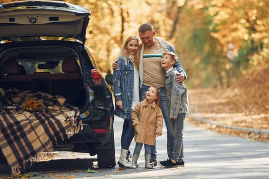 Cheerful people. Happy family is in the park at autumn time together.