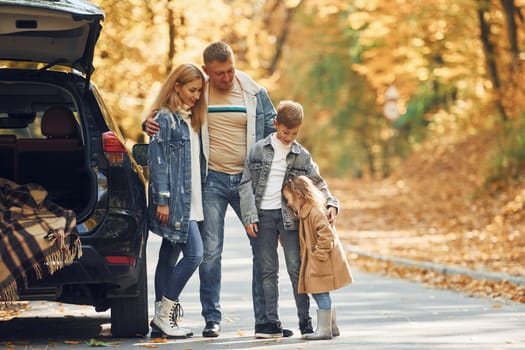 Cheerful people. Happy family is in the park at autumn time together.
