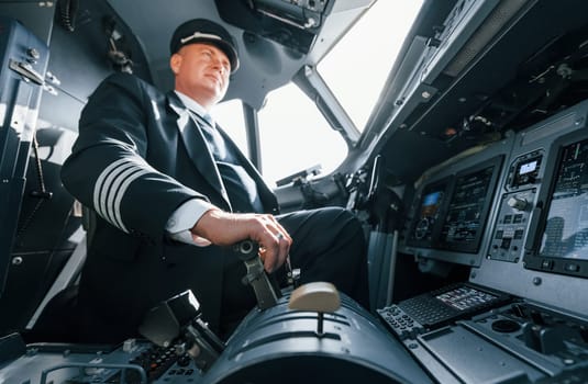 A professional pilot is in the cockpit. Conception of work.