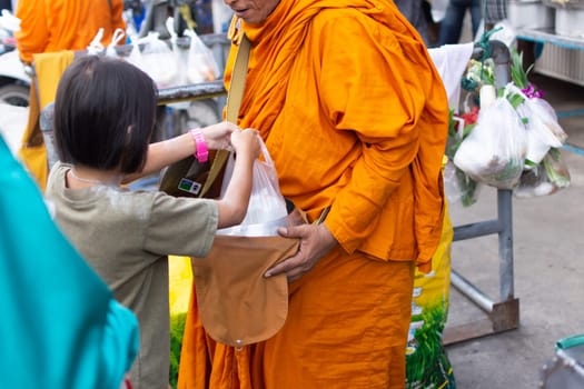 Bangkok, Thailand - October 24, 2016 : Unidentified thai monk ask for alms in morning for buddhist to make merit to offer food to the monks and receive blessing from the monks