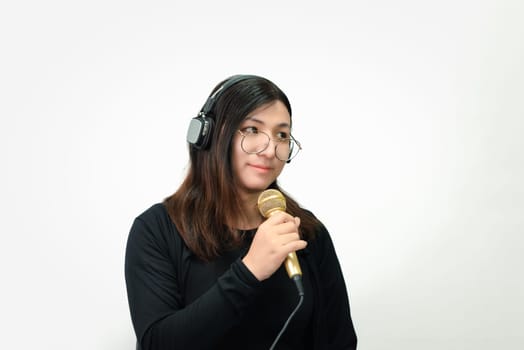 Beautiful asian woman (LGBTQ) is a singer. She enjoying sing a song or karaoke in music studio with microphone condenser and headphones for fun or voice creative