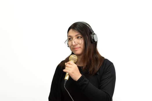 Beautiful asian woman (LGBTQ) is a singer. She enjoying sing a song or karaoke in music studio with microphone condenser and headphones for fun or voice creative