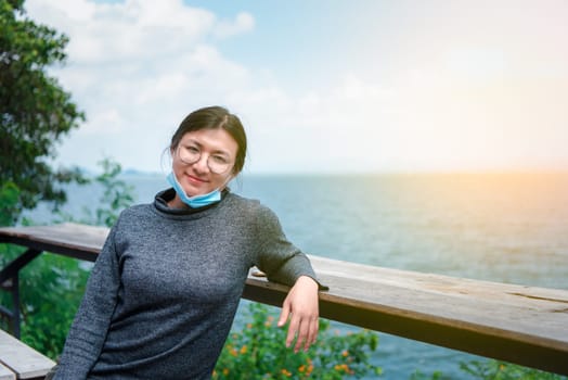 Beautiful asian woman (LGBTQ) natural makeup wear fashion relax clothes posing at sea viewpoint with happy and fun emotion in concept travel, vacation, leisure in life