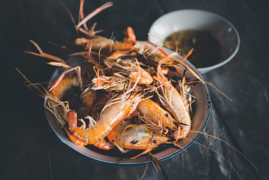 Grilled shrimp (Giant freshwater prawn) grilling with charcoal premium grade display for sale at Thai street food market or restaurant in Bangkok Thailand