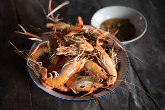 Grilled shrimp (Giant freshwater prawn) grilling with charcoal premium grade display for sale at Thai street food market or restaurant in Bangkok Thailand