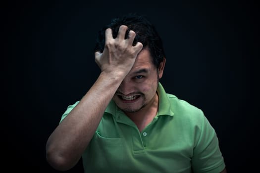 Asian man 40s strain have a anger unhappy gesture with stressed and problems concept on black background dark style