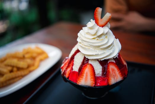 Bingsu or Bingsoo (Patbingsu) is a popular Korean shaved ice dessert with sweet toppings that may include chopped fruit, condensed milk, fruit syrup, and varieties with ingredients