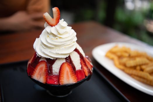 Bingsu or Bingsoo (Patbingsu) is a popular Korean shaved ice dessert with sweet toppings that may include chopped fruit, condensed milk, fruit syrup, and varieties with ingredients