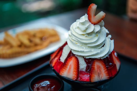 Bingsu or Bingsoo (Patbingsu) is a popular Korean shaved ice dessert with sweet toppings that may include chopped fruit, condensed milk, fruit syrup, and varieties with ingredients