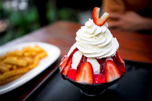 Bingsu or Bingsoo (Patbingsu) is a popular Korean shaved ice dessert with sweet toppings that may include chopped fruit, condensed milk, fruit syrup, and varieties with ingredients