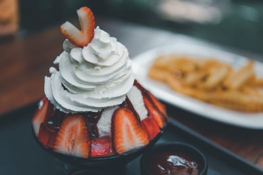 Bingsu or Bingsoo (Patbingsu) is a popular Korean shaved ice dessert with sweet toppings that may include chopped fruit, condensed milk, fruit syrup, and varieties with ingredients