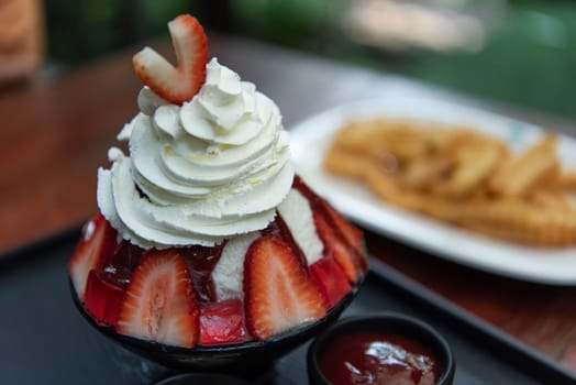 Bingsu or Bingsoo (Patbingsu) is a popular Korean shaved ice dessert with sweet toppings that may include chopped fruit, condensed milk, fruit syrup, and varieties with ingredients