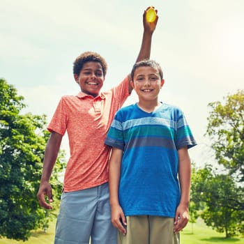 His turn to get wet. adorable young boys playing with water balloons outdoors