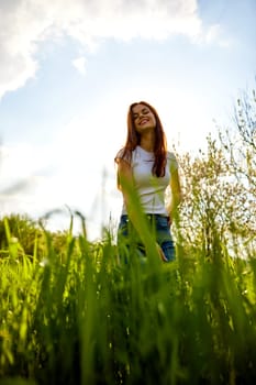 bright, happy woman posing while standing in tall grass. High quality photo