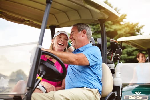 Its the only way to get travel on a golf course. an affectionate mature couple spending a day on the golf course