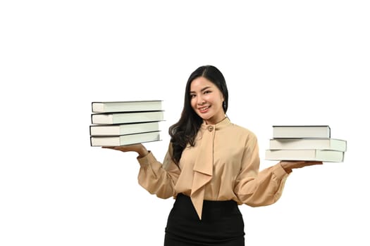 Beautiful young woman holding books standing isolated on white background. Education concept.