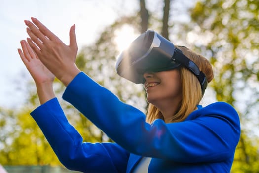 Girl stretched her hands to the sky in glasses of virtual reality.