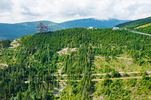 Sky walk observation tower in the forest between mountain hills near Sky Bridge 721 in a sunny summer day, Dolni Morava, Czech Republic