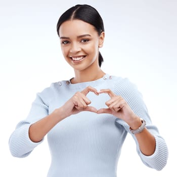 Face portrait, studio and happy woman with heart hand sign for romantic love, care and support. Valentines day, happiness and isolated person with emoji icon gesture for kindness on white background.