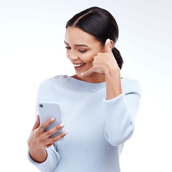 Phone call, sign and woman isolated on a white background for networking, contact and communication on mobile app. Happy young person talking, hello or conversation on cellphone service in studio.