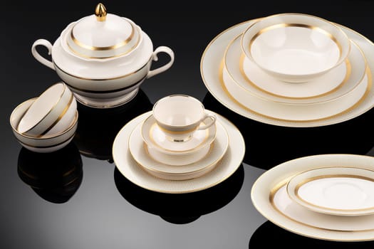 A luxury tableware set on black reflective surface