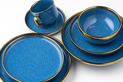 A set of blue ceramic plates and cup on a white background