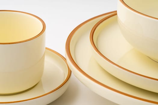 A set of white and brown ceramic plate and cup. Close-up