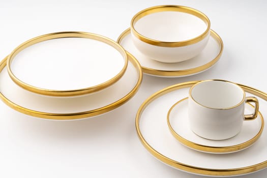 A set of white and brown ceramic plate and cup on a white background