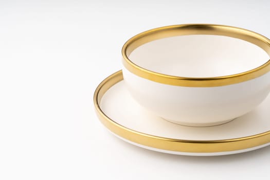 A set of white and brown ceramic plate and cup on a white background