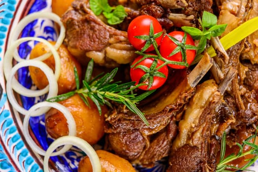 A top view of a national Uzbek dish with meat and potatoes