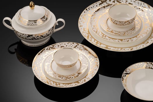 A luxury tableware set on black reflective surface