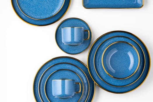 A set of blue ceramic plates and cup on a white background. Top view