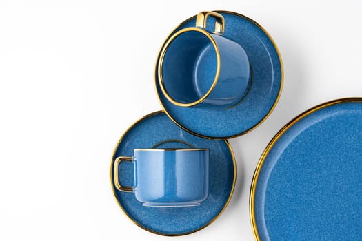 A set of blue ceramic plates and cup on a white background. Top view