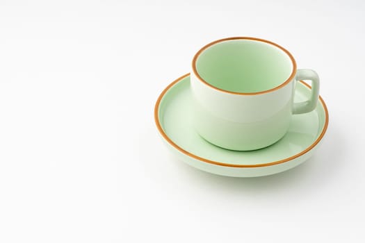 A green ceramic tea cup isolated on white background