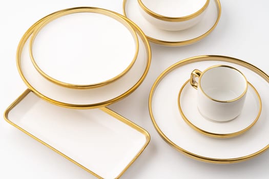 A set of white and brown ceramic plate and cup on a white background