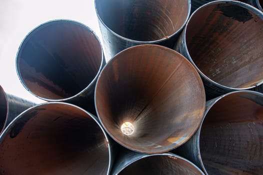 A line of oilfield large streel pipes, front view