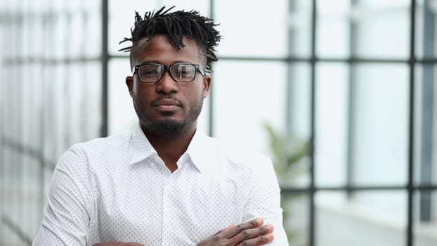 Portrait of a serious Black businessman with arms folded