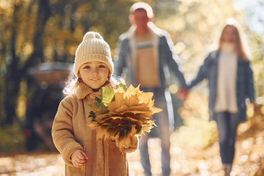 Beautiful leaves. Happy family is in the park at autumn time together.