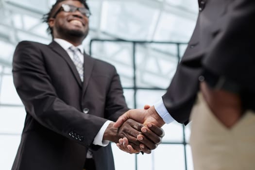 Businessman shaking hands with colleague after meeting in office