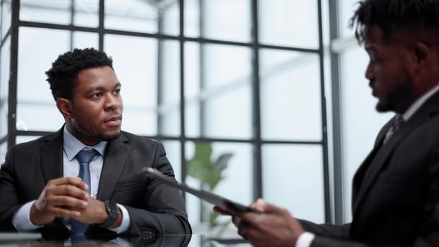 african american male business partners discussing a project in the office