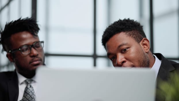 Technology that matches their target driven company. Shot of a young businessman using a computer in a modern office.