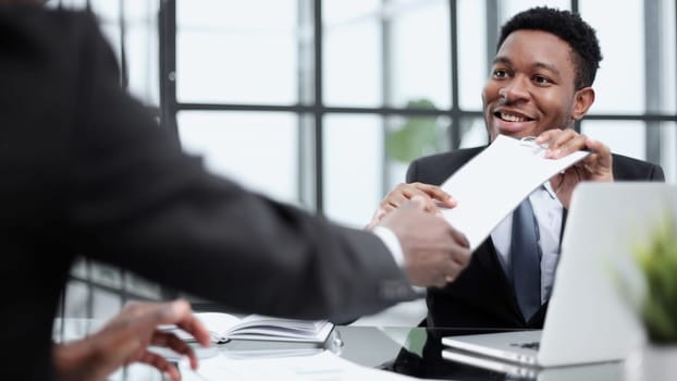 Shot of two young businesmen shaking hands in a modern office