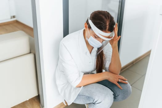 Feeling bad and tired. Professional medic in white coat is in the clinic.