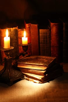 Nice vintage candlestick on background with old books