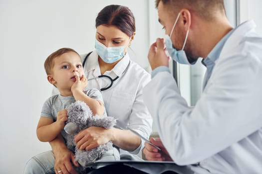 Qualified help. Two doctors in white coats is in the clinic working together.